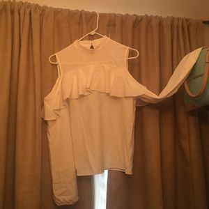 White blouse with cold shoulder and ruffle detail.